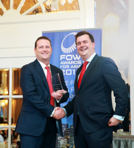 TT accepts the award for Trading System of the Year, Buy-Side from FOW's Will Mitting (R) at the FOW Awards for Asia in Singapore.